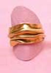 gold ring that looks like fabric has been folded or compressed together.